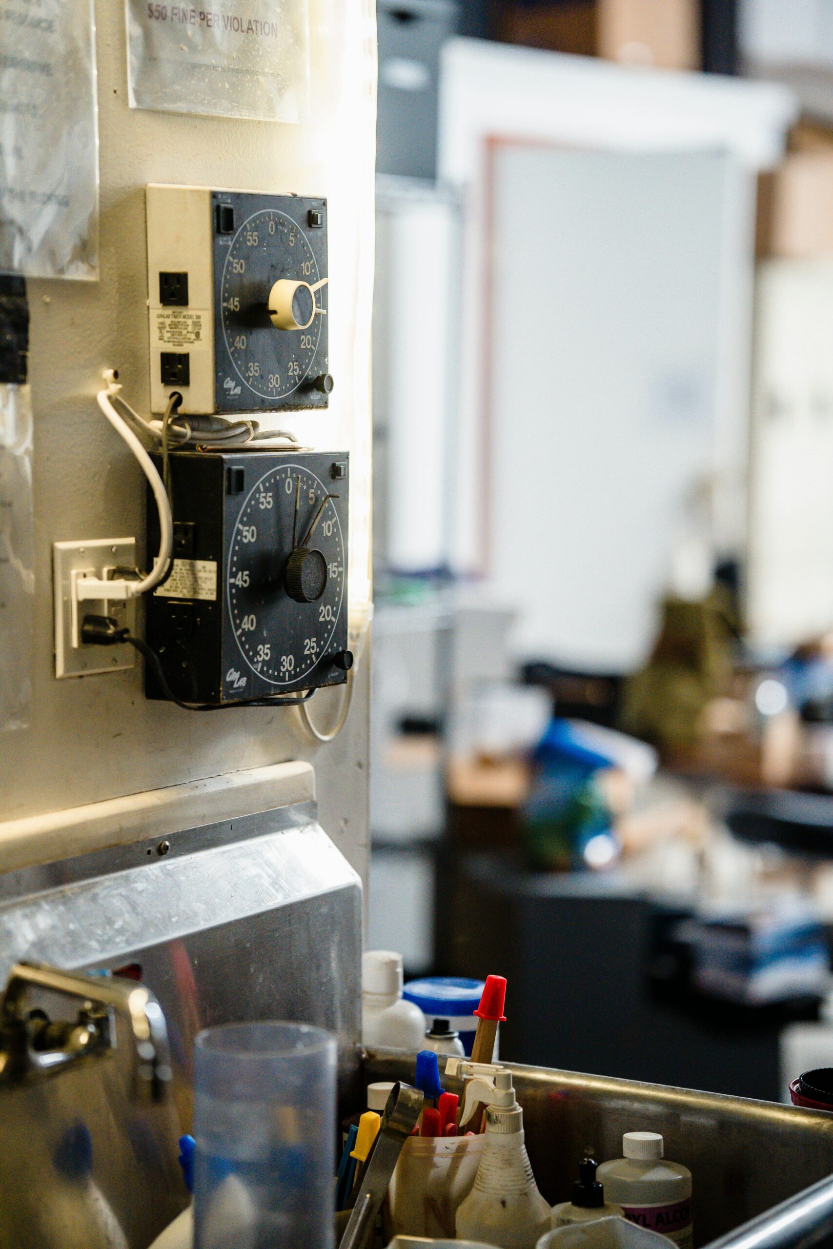 Detailed view of timers and equipment in a busy workshop environment.